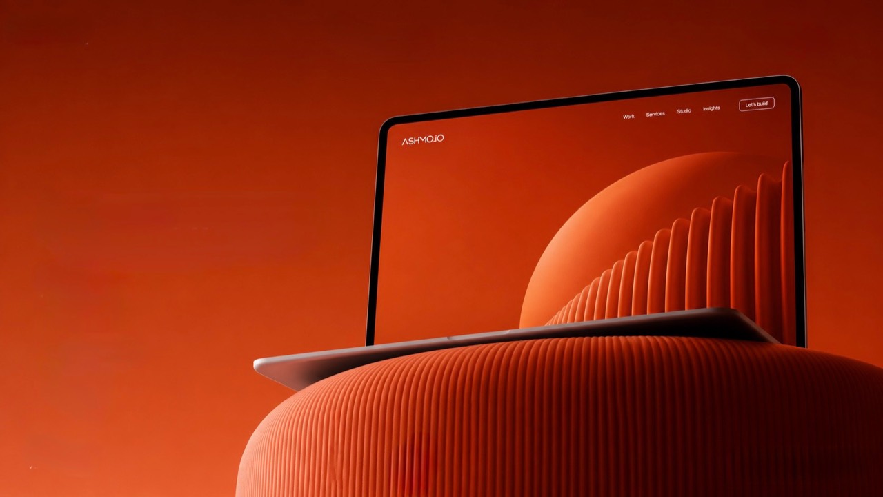 Ashmo.io website displayed on an orange sculptural digital scene
